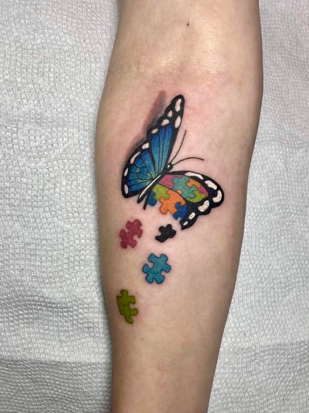 Symbolic butterfly tattoo with puzzle pieces Tattoo Design
