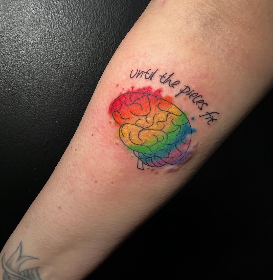 Vibrant rainbow brain tattoo with inspiring message Tattoo Design
