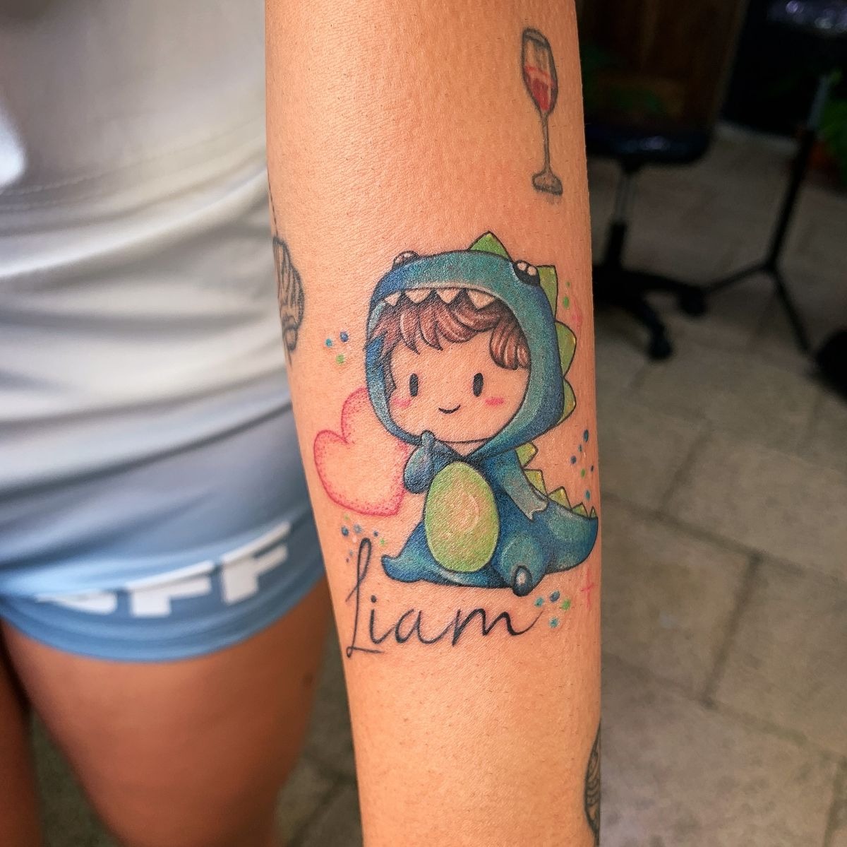 Colorful Baby Dino Tattoo With Name Tattoo Design