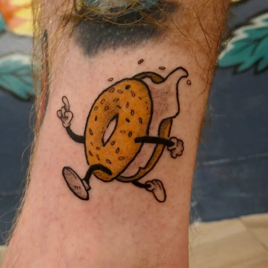 A whimsical tattoo featuring a playful bagel Tattoo Design