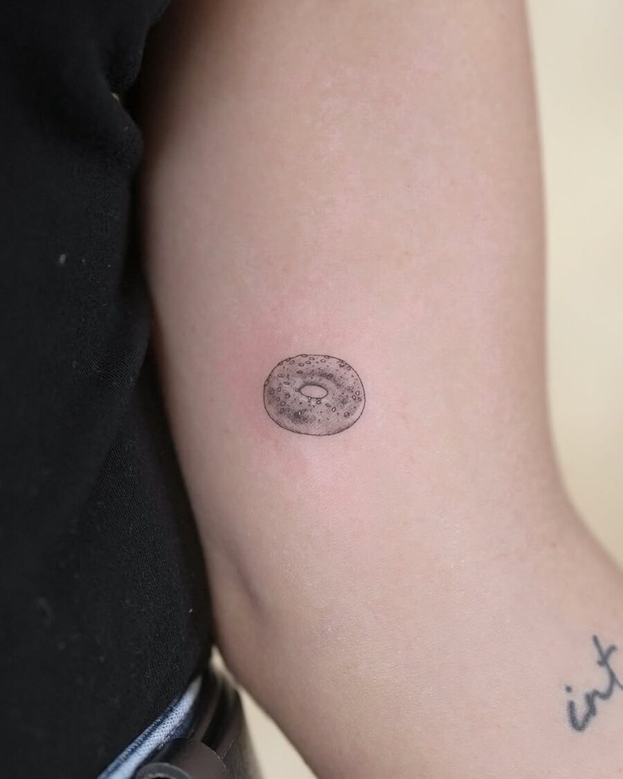 Charming minimalist bagel tattoo on the arm Tattoo Design