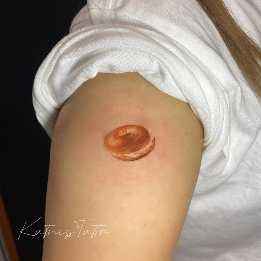 Realistic bagel tattoo on the arm Tattoo Design