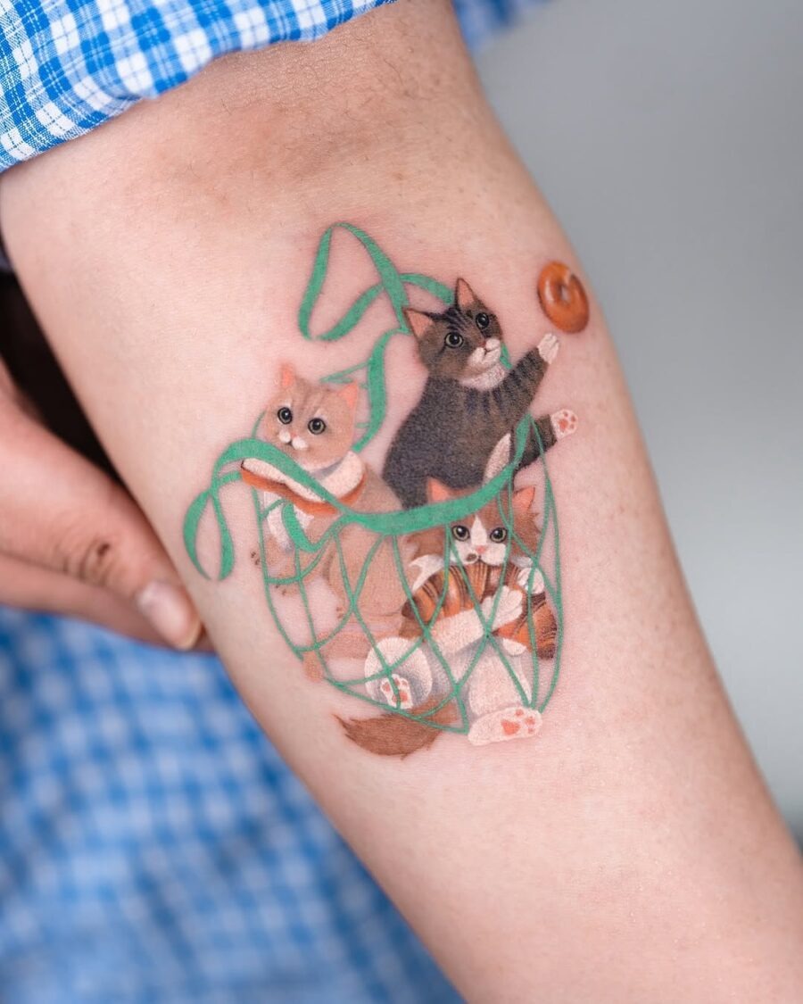 Whimsical bagel tattoo with playful cats Tattoo Design