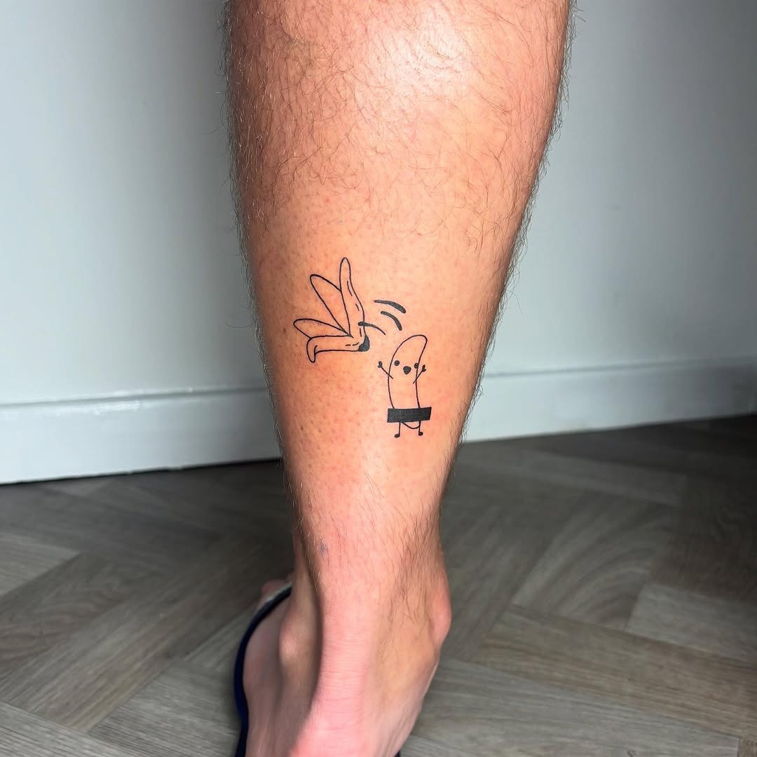 This cute banana tattoo features a cheerful banana character waving.