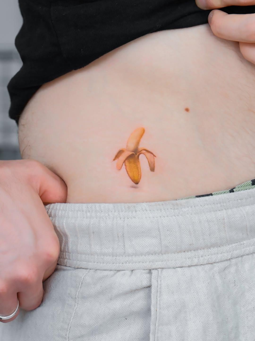 This banana tattoo features realistic detailing, showing the playful nature of body art.