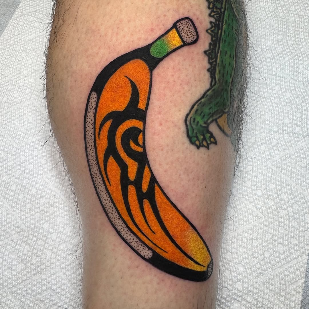 This tattoo showcases a visually striking banana design with a tribal twist.
