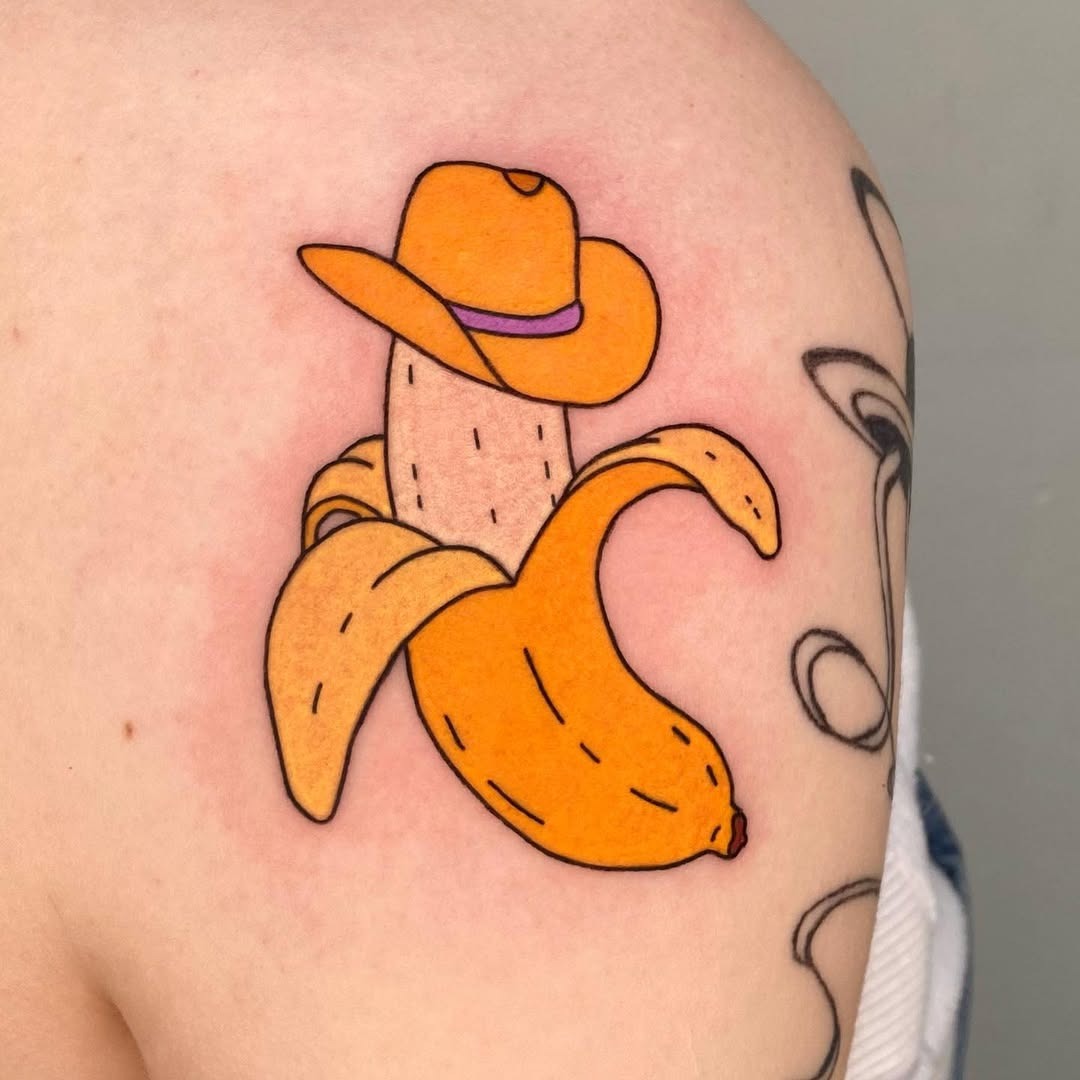 This playful tattoo features a cheerful banana wearing a cowboy hat, adding a fun twist to traditional fruit tattoos.