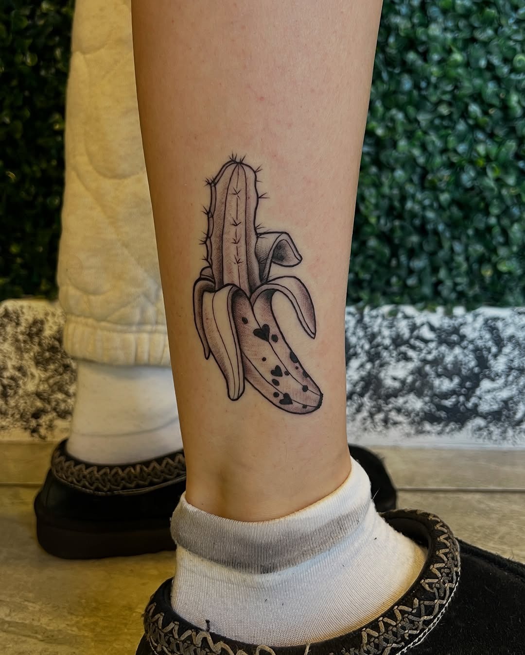 This tattoo creatively combines a banana with cactus features, giving it a playful twist.