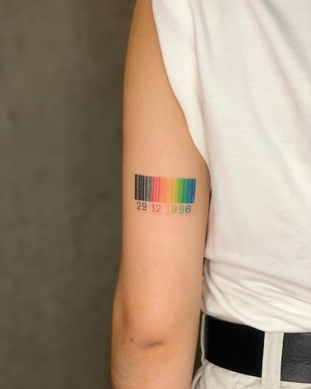 This tattoo features a sleek barcode design adorned with a gradient of colors.