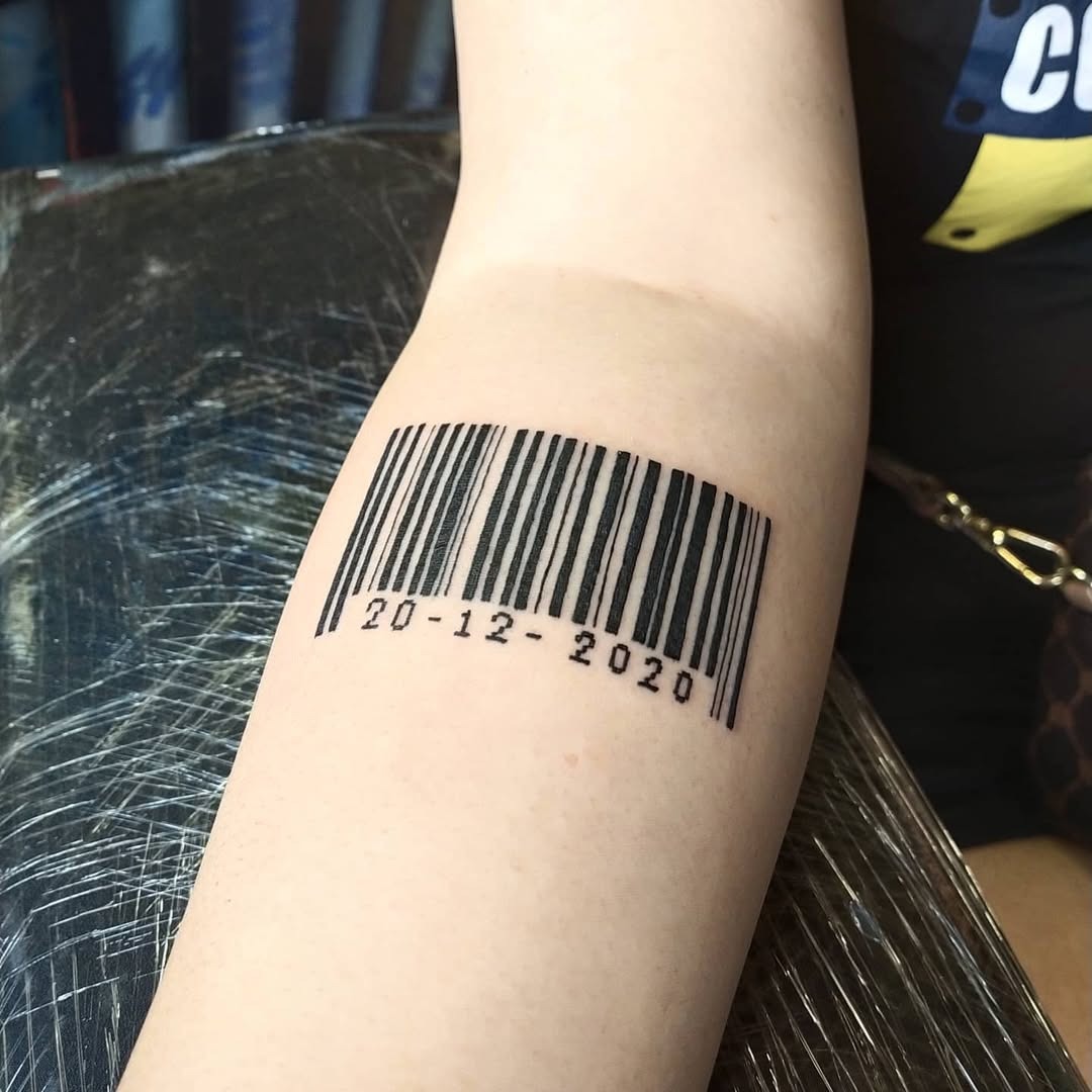This tattoo showcases a sleek barcode design inked on the arm.