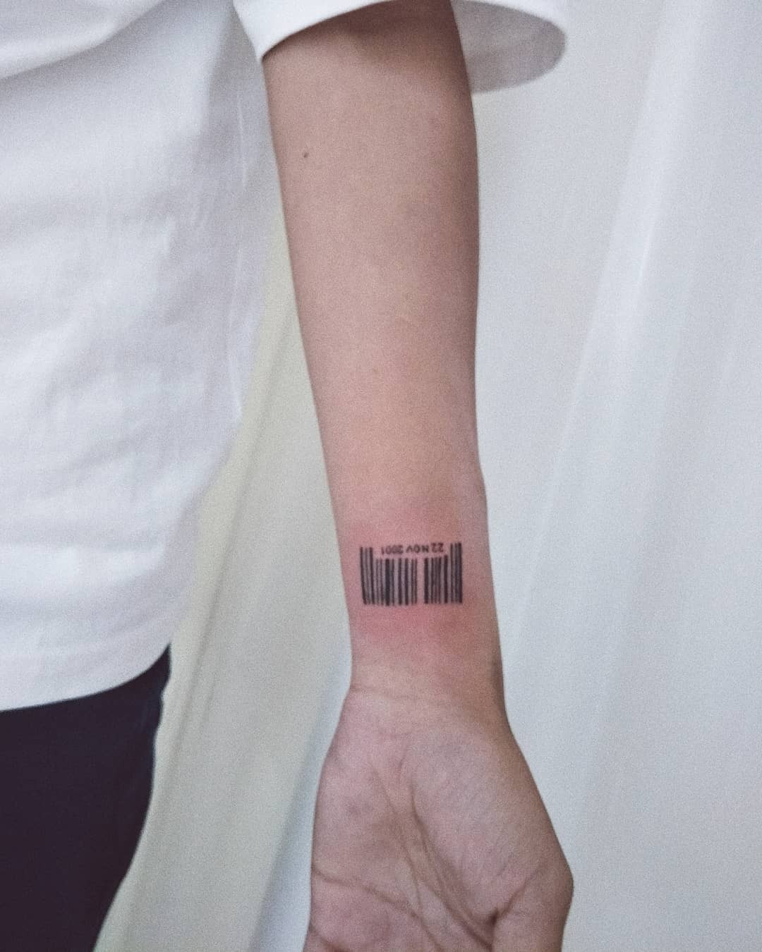 This barcode tattoo features a simple and clean design etched on the forearm.