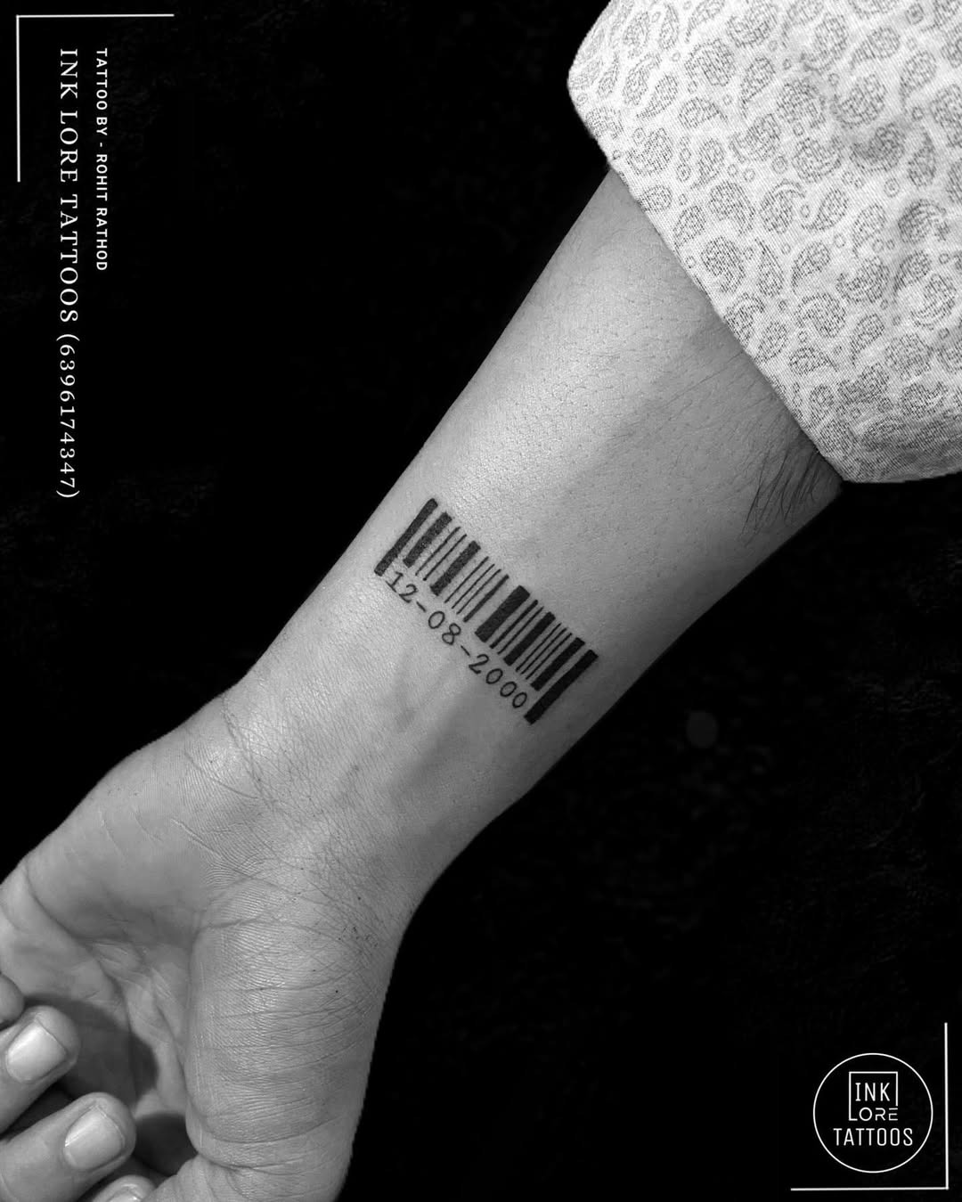 This tattoo features a sleek barcode inked on the forearm.