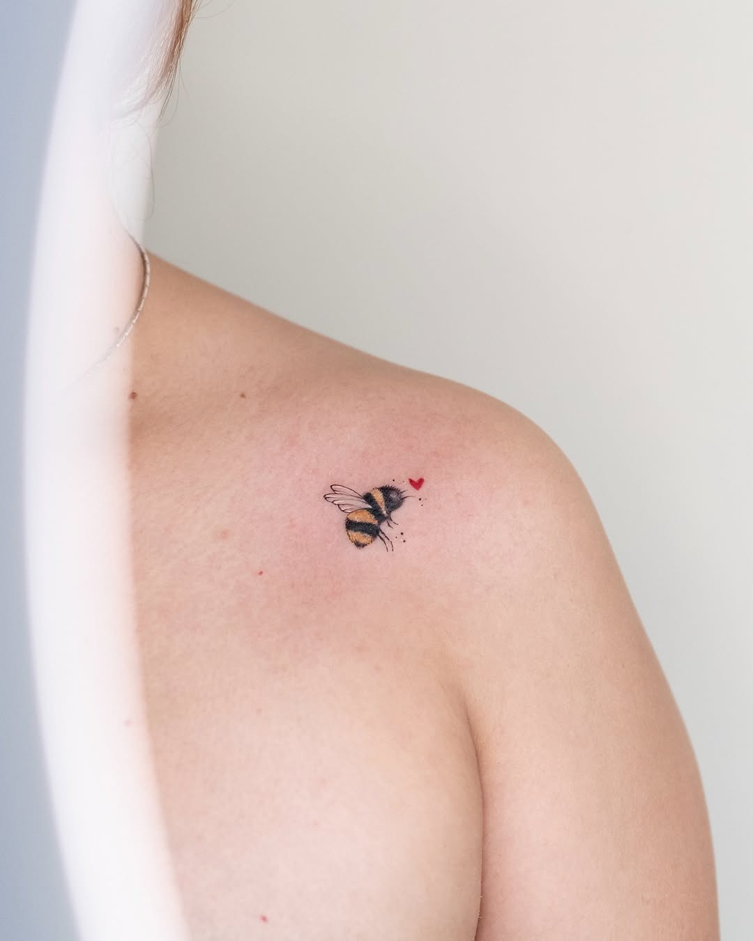 Charming bumblebee tattoo with heart accents Tattoo Design