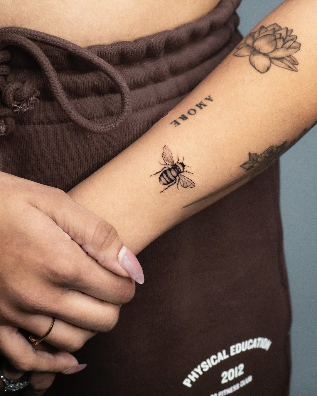 Elegant minimalist bee tattoo on the forearm Tattoo Design