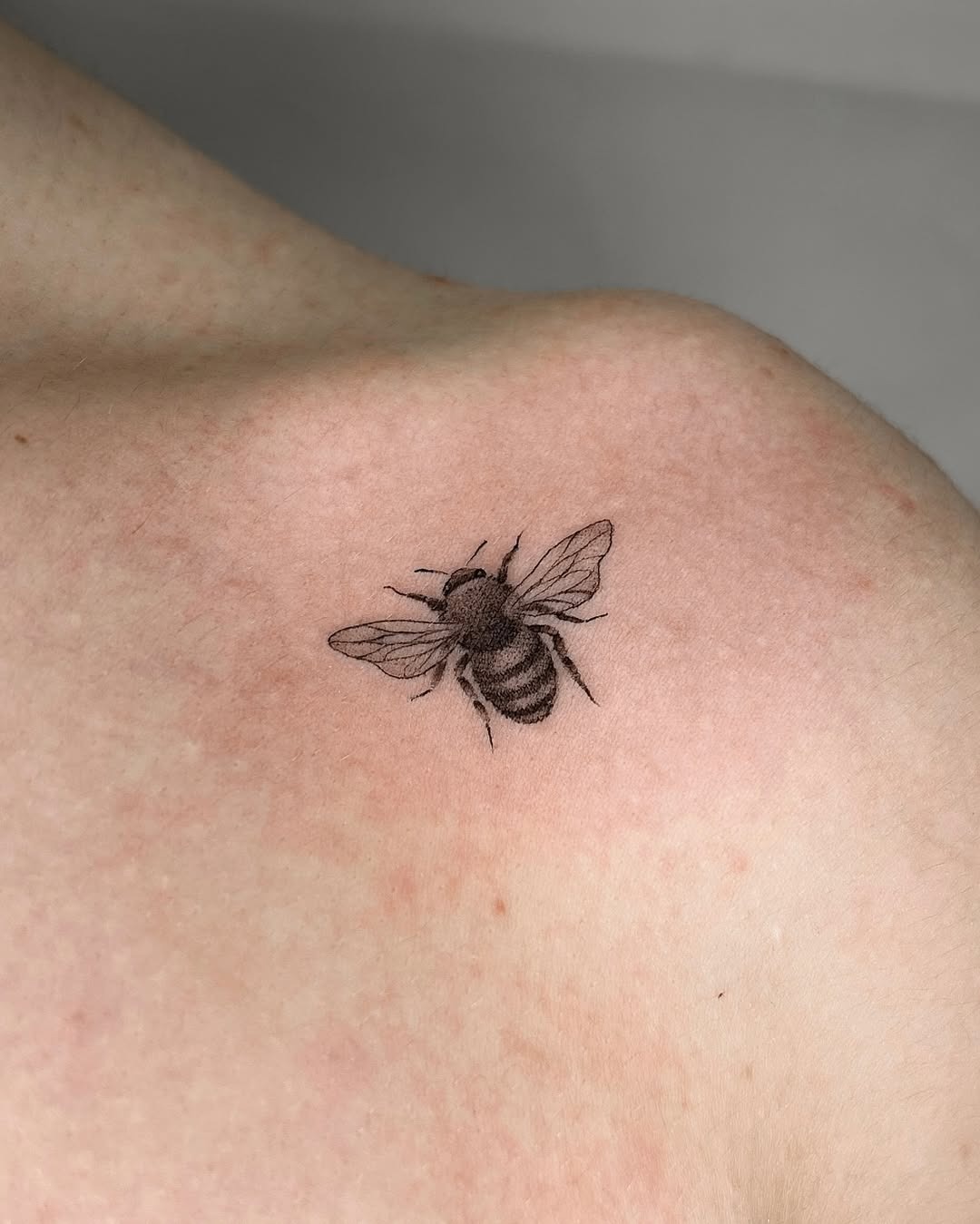 Elegant minimalistic bee tattoo design on shoulder Tattoo Design
