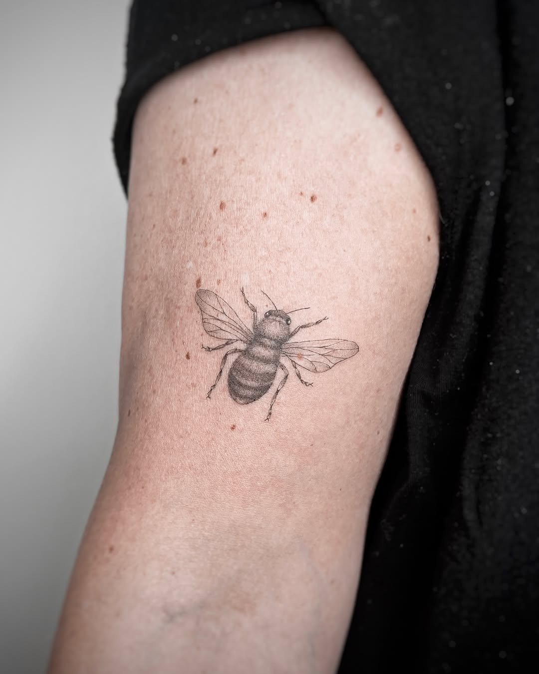 Realistic bee tattoo on the arm Tattoo Design
