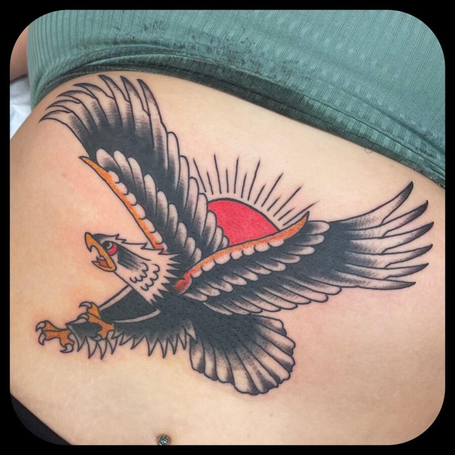 This stunning belly tattoo features a majestic eagle in flight, its wings majestically spread wide.