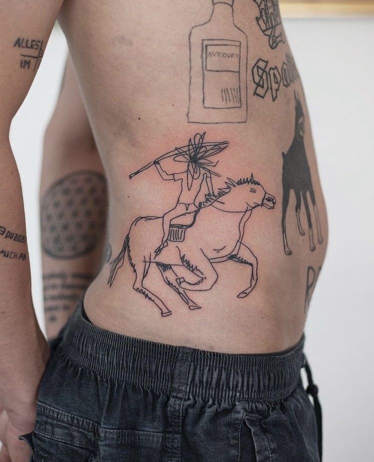 This unique belly tattoo features a horseman gripping a spear, captured in bold black line art.