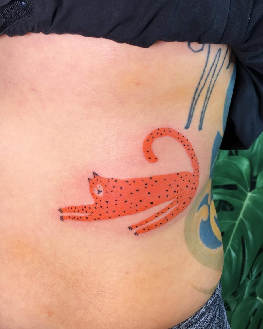 This belly tattoo features a playful red cat stretching, its dotted pattern creating a visual.