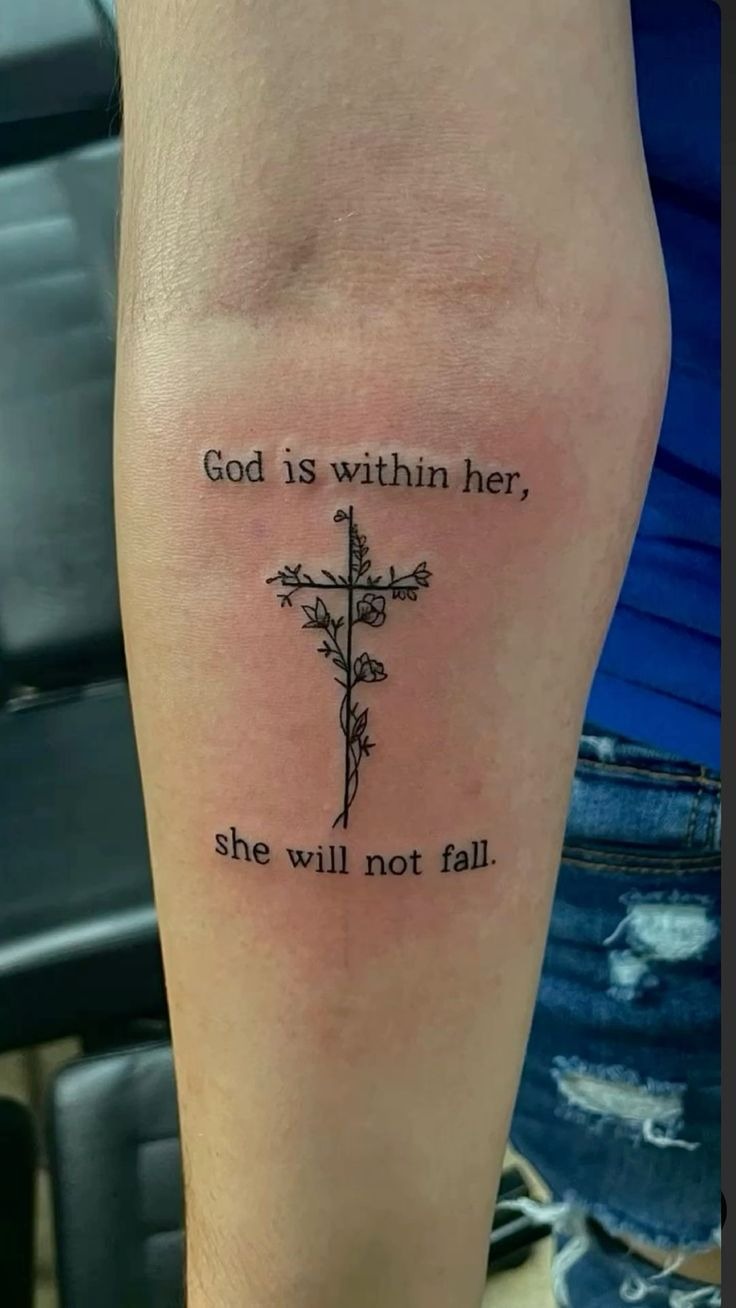 God is Within Her Floral Cross Tattoo, a tattoo design rendered in delicate fine-line for the leg.