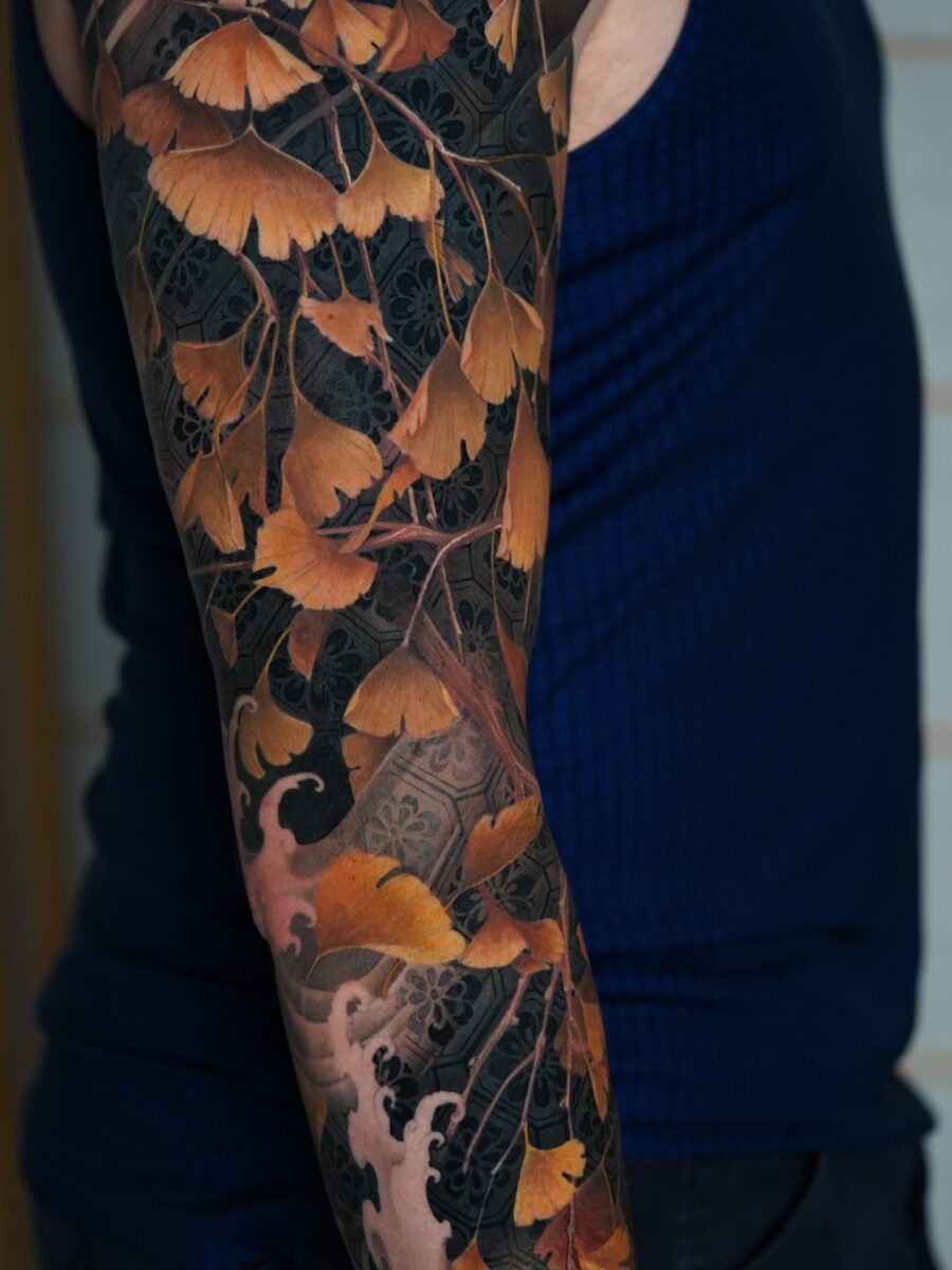 Elegant floral bicep tattoo with Japanese lettering Tattoo Design
