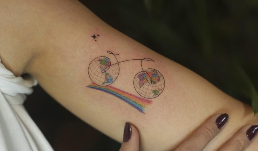 Whimsical bike tattoo with rainbow accents Tattoo Design