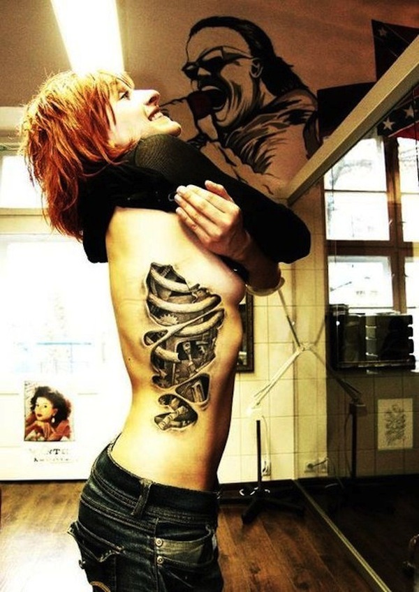 Revealing Woman’s Ribs Biomechanical Tattoo in Grayscale Tattoo Design