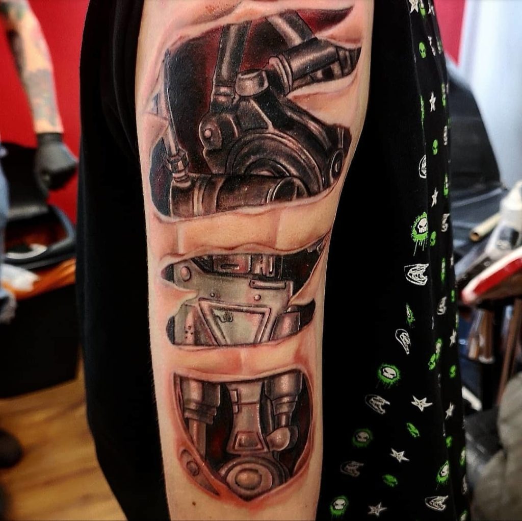 Ripped Skin Biomechanical Tattoo on Arm Tattoo Design