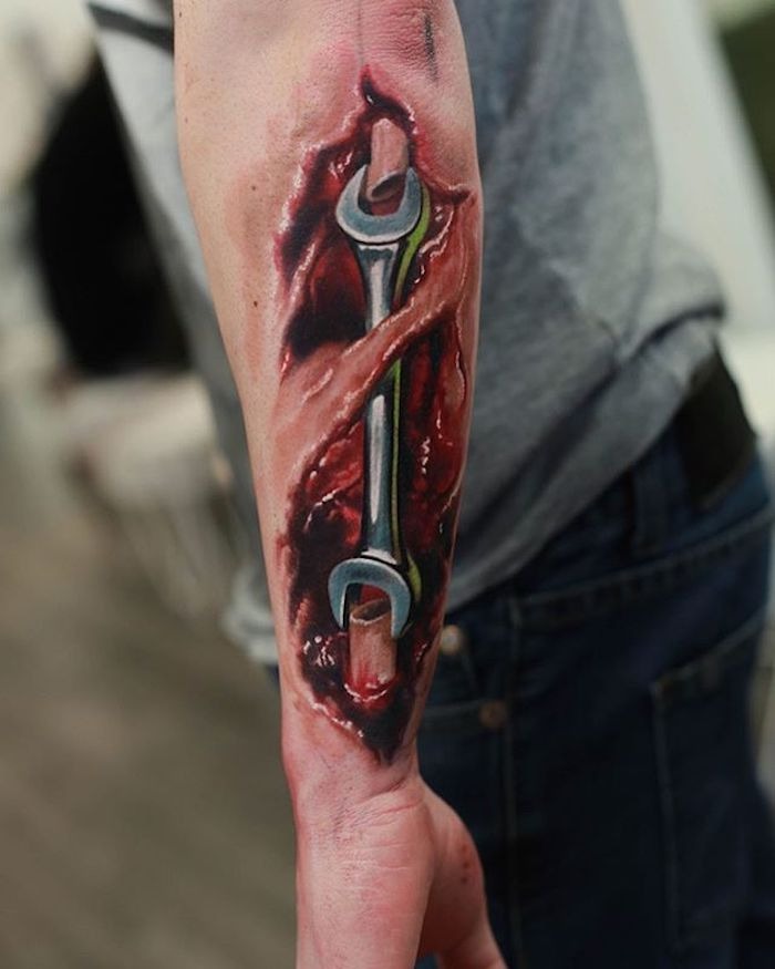 Wrench as Arm Bone Colored Biomechanical Tattoo Tattoo Design