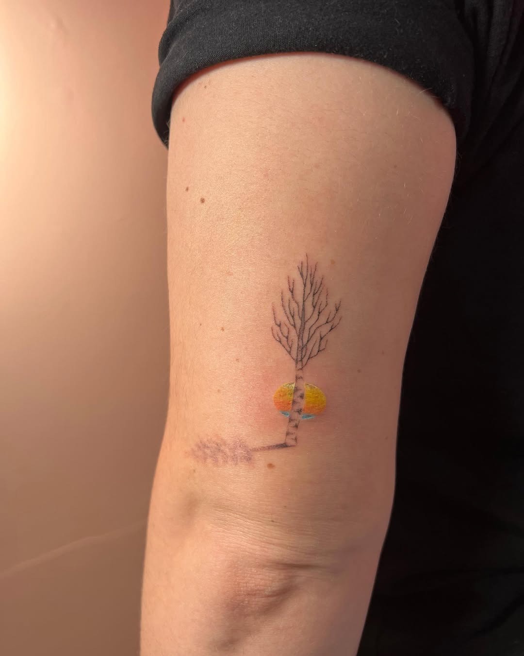 This birch tree tattoo features a delicate design that captures the essence of nature.