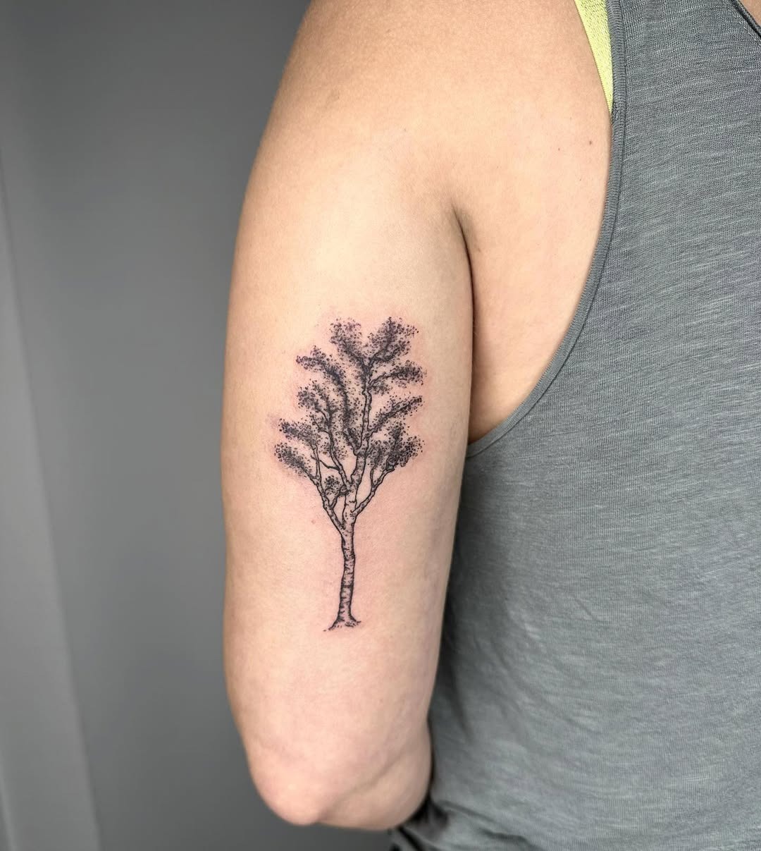 This tattoo features a delicate depiction of birch trees, showing their beautiful bark and slender forms.