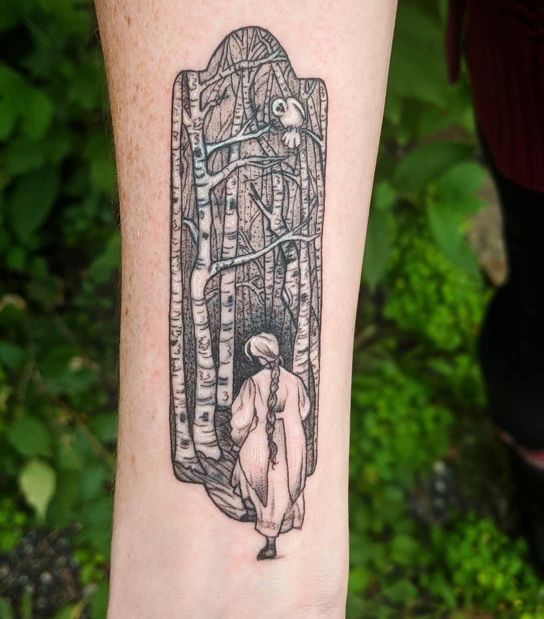 This tattoo features a beautiful scene of birch trees, drawing the viewer into a tranquil forest.