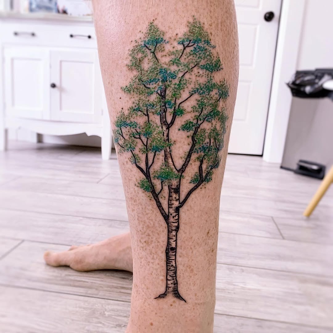 This tattoo captures the graceful beauty of a birch tree.