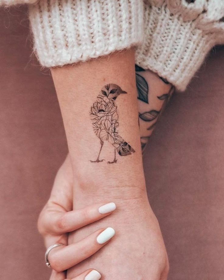 Floral Silhouette Bird on Wrist Tattoo Design