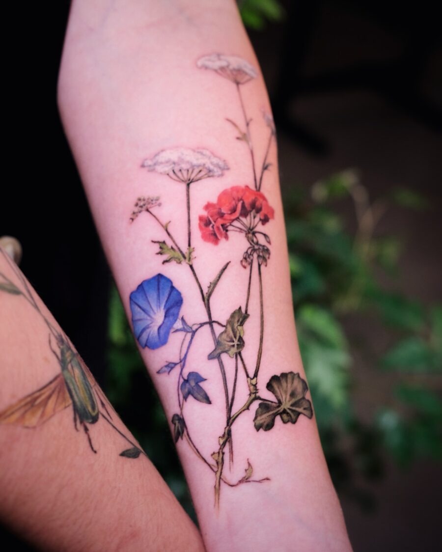 This tattoo showcases a stunning variety of flowers, beautifully inked on the arm.