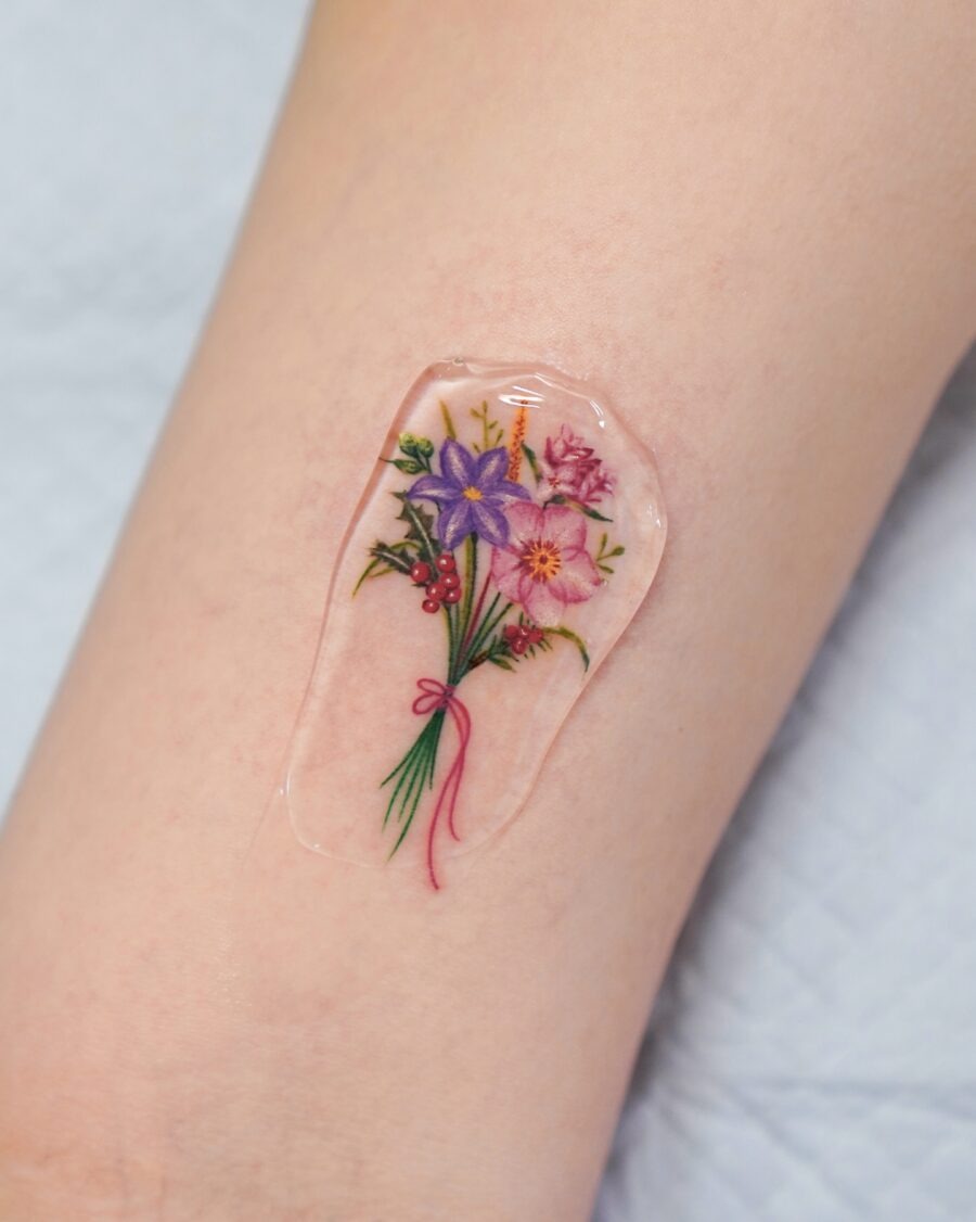This tattoo showcases a bouquet of birth flowers, each symbolizing unique meanings.