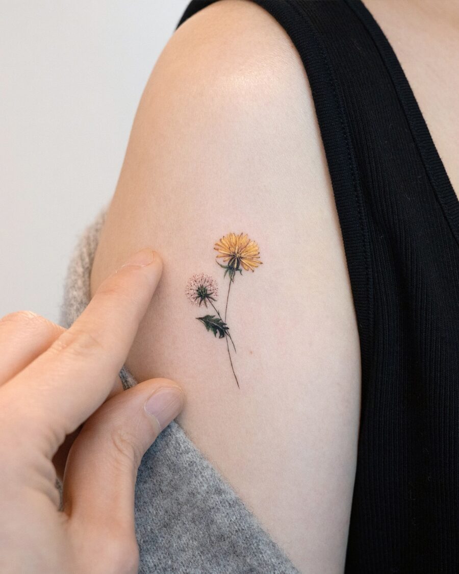 This tattoo showcases a beautiful arrangement of flowers on the inner arm.