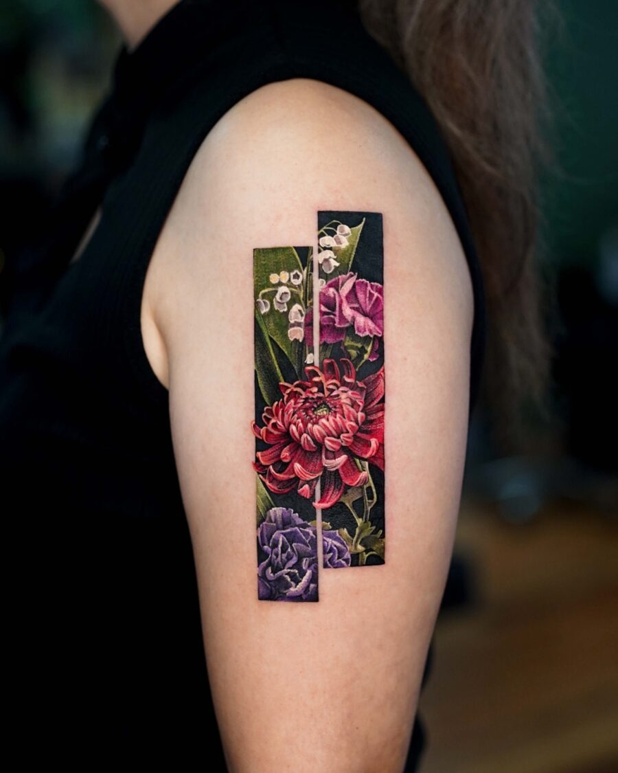 This tattoo showcases, artistic floral designs on a person's upper arm.