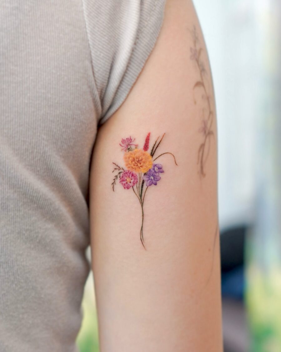 This tattoo features a colorful bouquet of flowers, capturing the essence of nature's beauty.