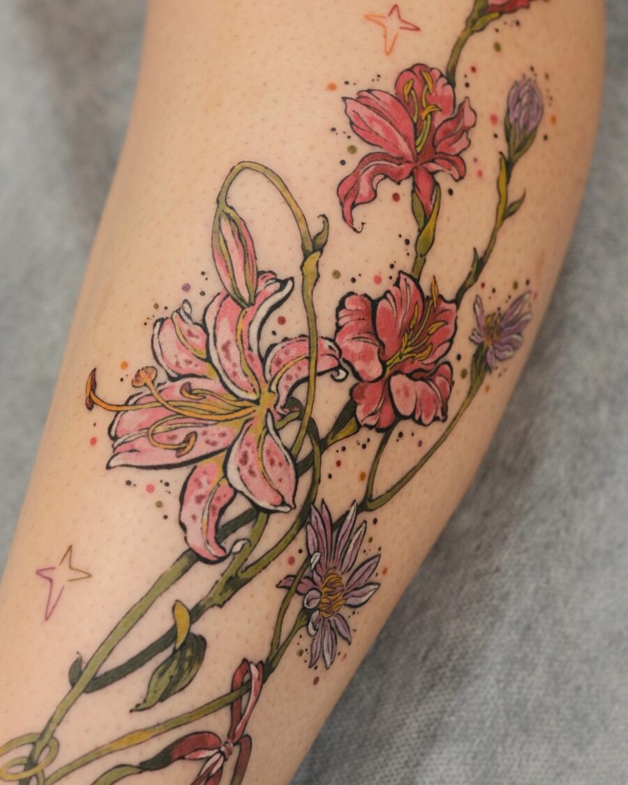 This stunning tattoo features a blend of lilies and delicate flowers, creating a captivating design.