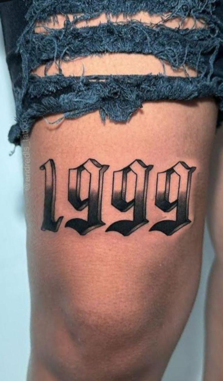 Bold 1999 Thigh Statement Tattoo Design