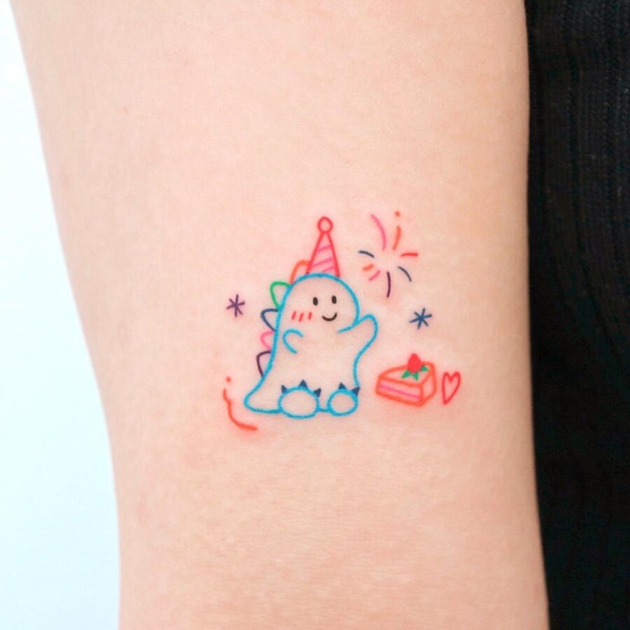 This quirky tattoo features a cheerful dinosaur wearing a party hat, radiating joy and celebration.