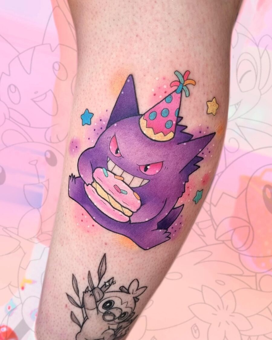 This tattoo features a, mischievous character wearing a party hat while holding a delicious cake.