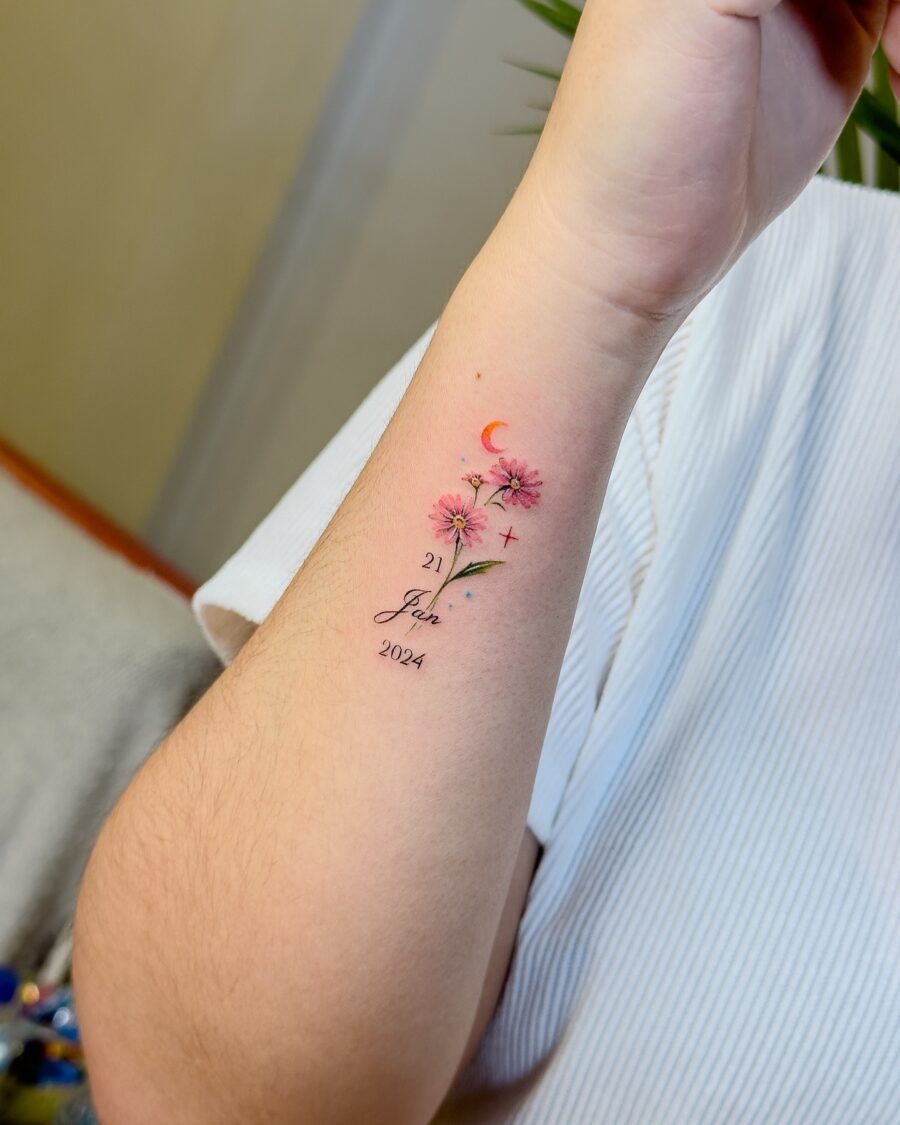This tattoo features delicate flowers combined with a crescent moon, capturing a soft, whimsical vibe.