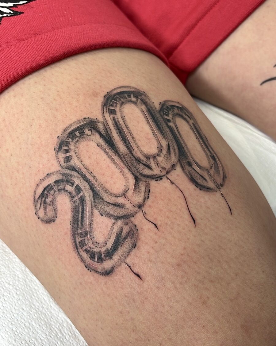 This tattoo showcases three balloon numbers, '200', symbolizing a special milestone.