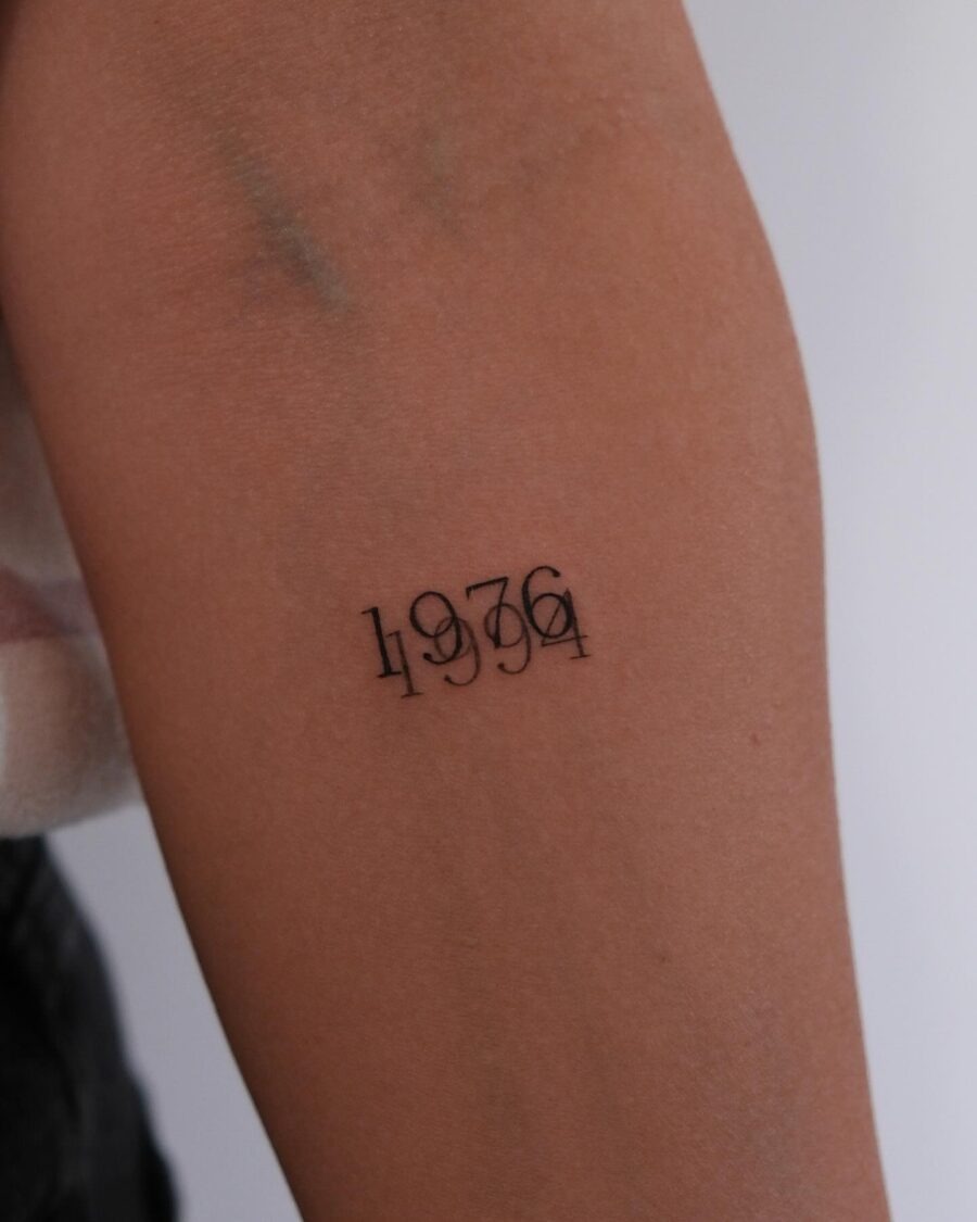 This tattoo features the year 1936 in a sleek, minimalist style.