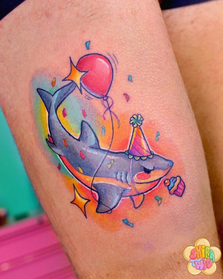 This shark tattoo brings a playful birthday spirit.