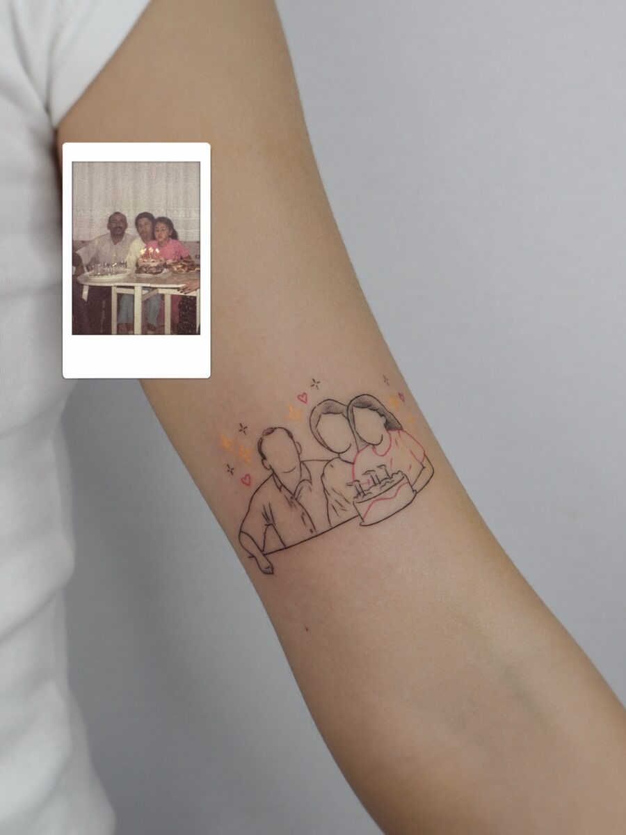 This tiny cake tattoo features minimalistic line art, embodying the spirit of birthdays.