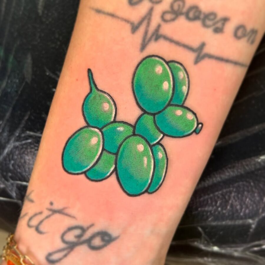 This balloon animal tattoo is a fun birthday homage, radiating joy and playfulness.