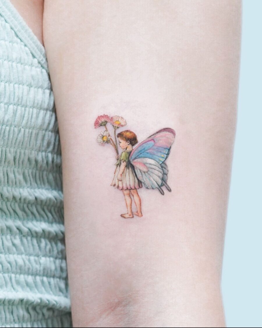 This enchanting tattoo showcases a delicate girl with beautiful butterfly wings, holding flowers.